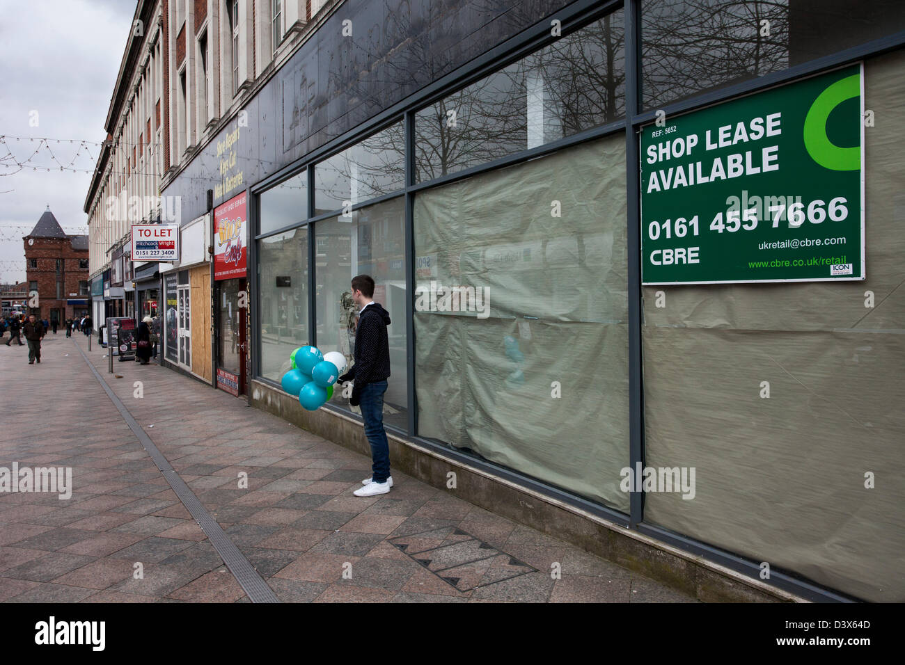Shop Lease Available People and the streets and shops of rundown Warrington town centre in decline. Borough in the area of Cheshire, England, UK Stock Photo