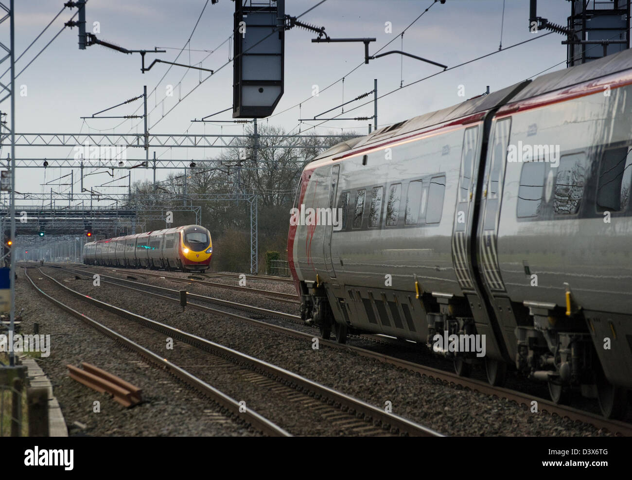 Class 390 Pendolinos approach one another at speed on the WCML near Rugby, Warwickshire on 21 February 2013 Stock Photo