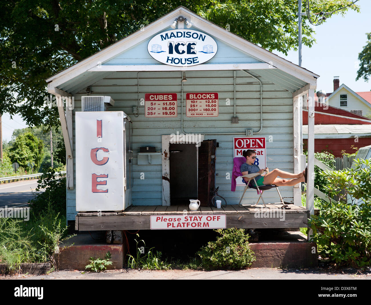 Americana. The old Madison Ice house, a living historic landmark, with a young teen selling Ice during the hot summer in CT USA Stock Photo