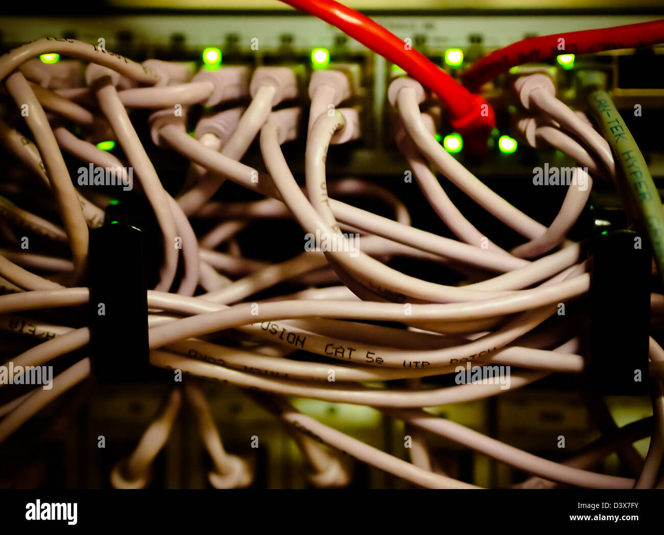Tangled router cables plugged into a commercial server Stock Photo
