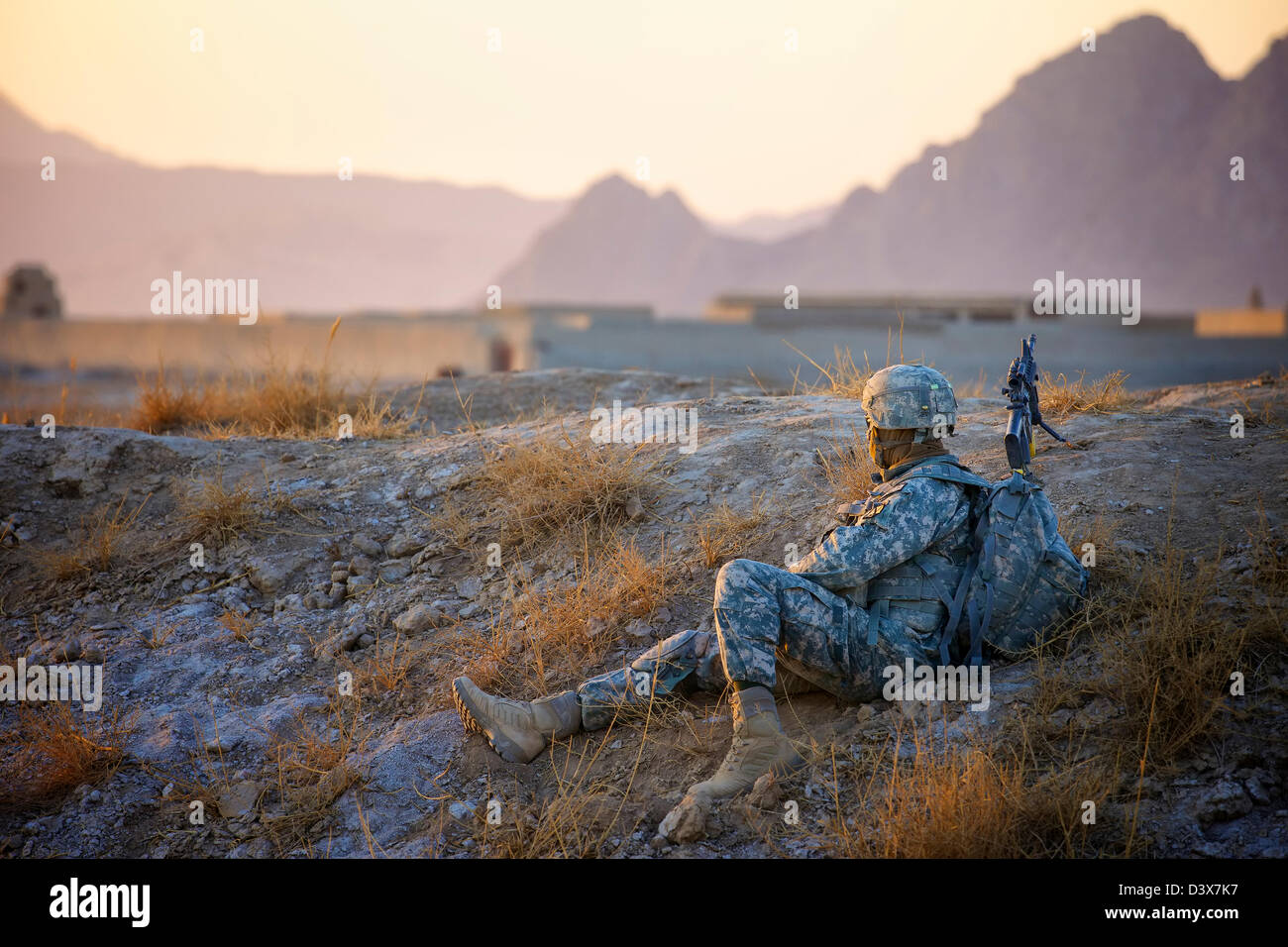An American Soldier keeps watch during a patrol in Kandahar Province, Afghanistan. Stock Photo