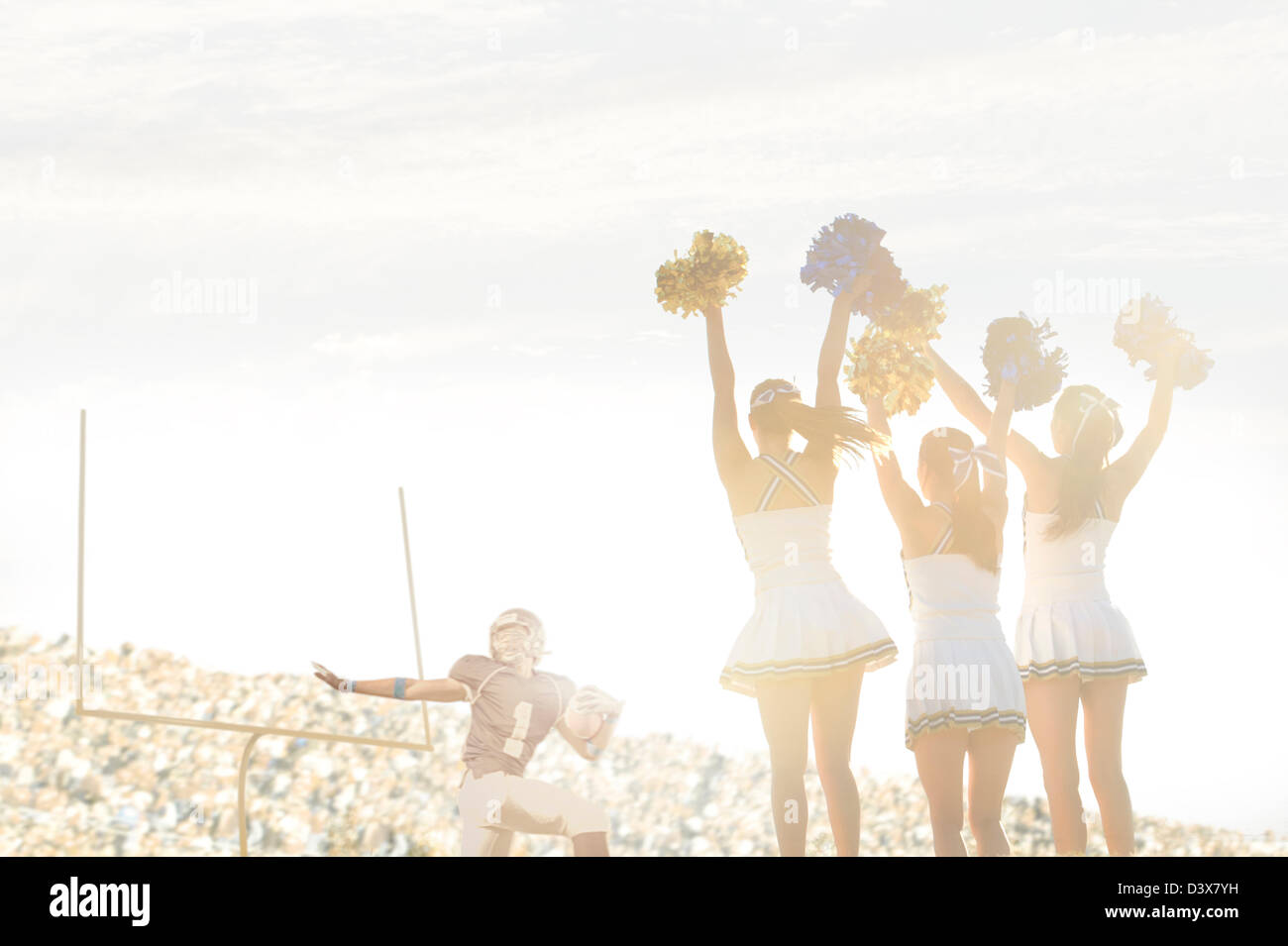 Caucasian cheerleaders on sidelines at football game Stock Photo