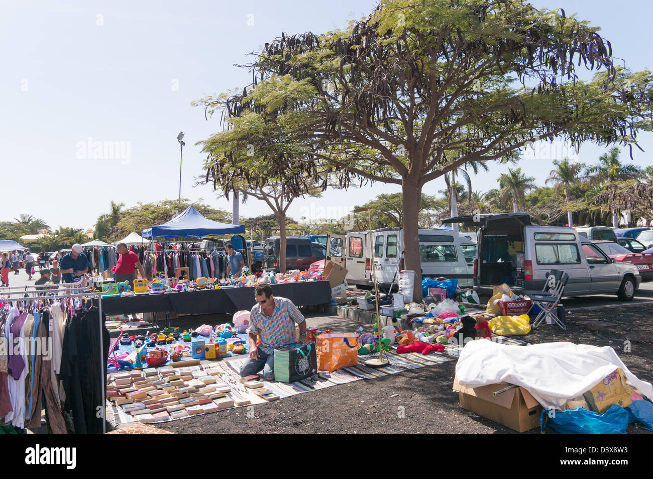Male stall holder packs away at the  flea market Playa del Inglés, Gran Canaria Stock Photo