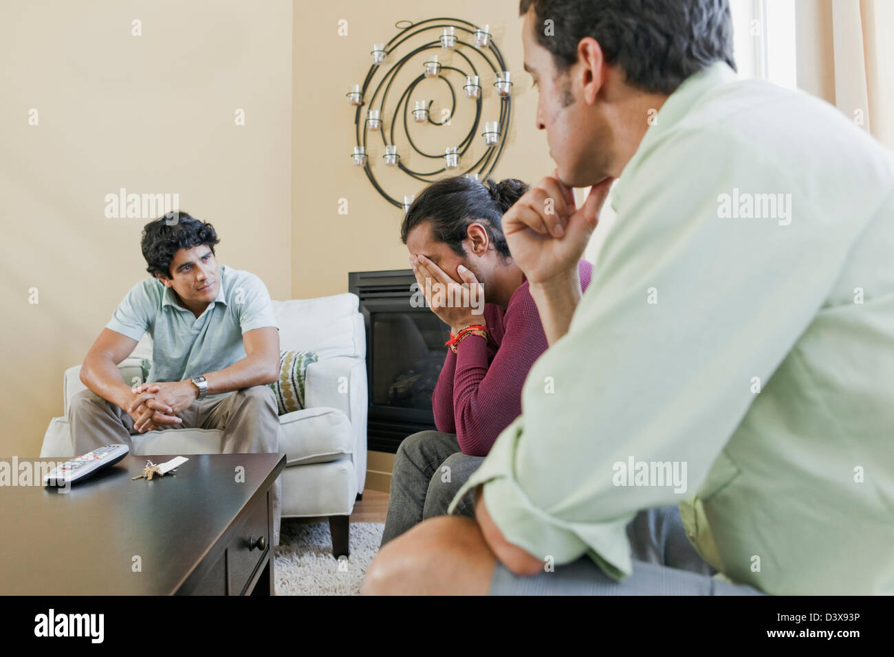 Mexican-American Men Helping Friend Solve Personal Problems by Group Intervention Stock Photo