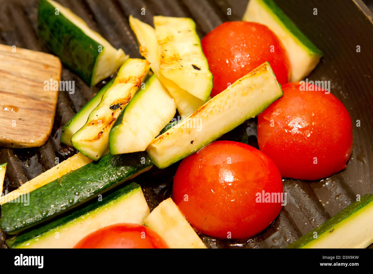 and tomatoes frying in a griddle pan Stock Photo Alamy