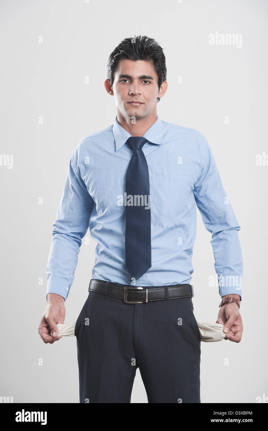 Businessman showing his empty pockets Stock Photo Alamy