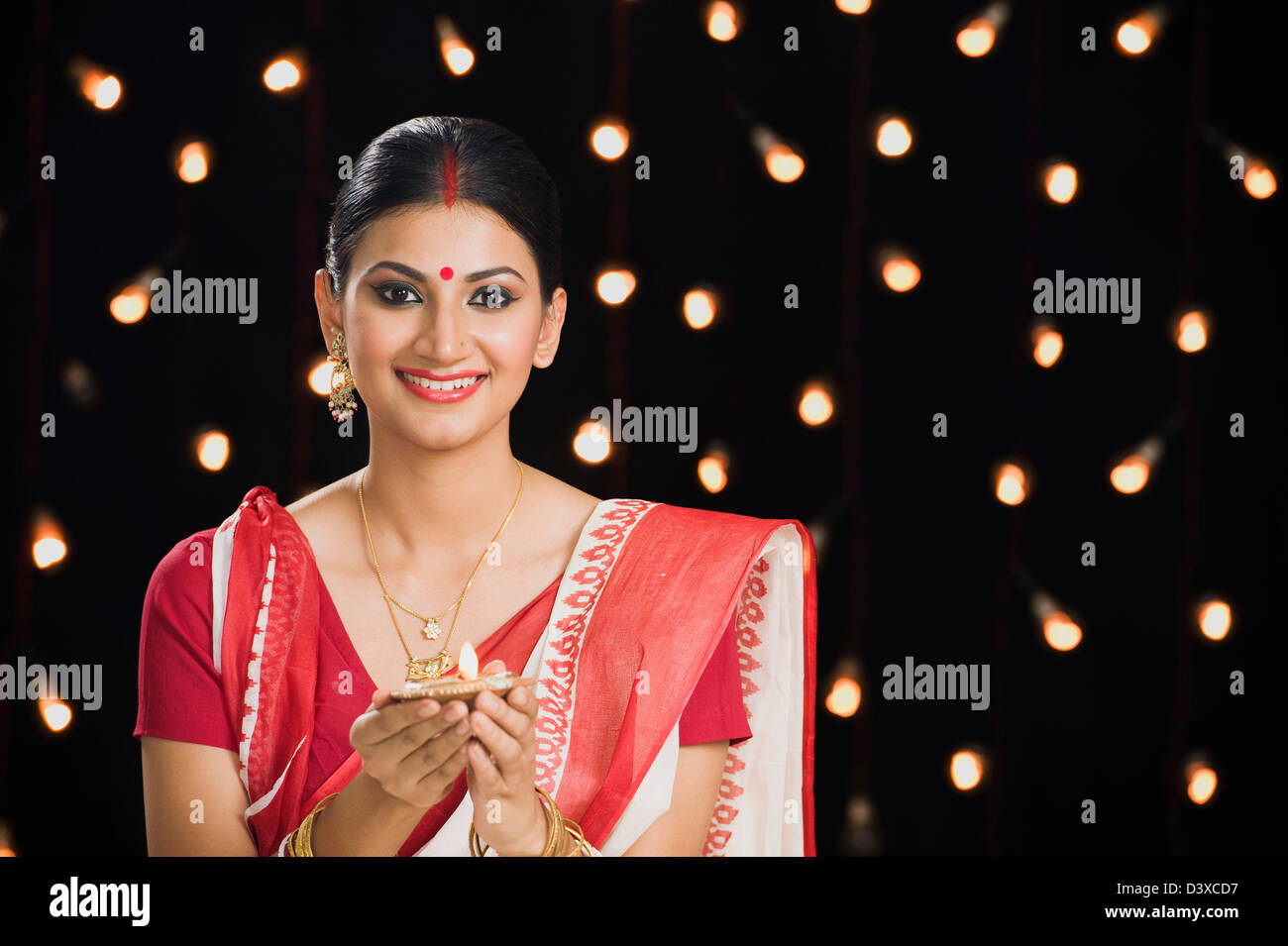 Bengali woman holding an oil lamp Stock Photo Alamy