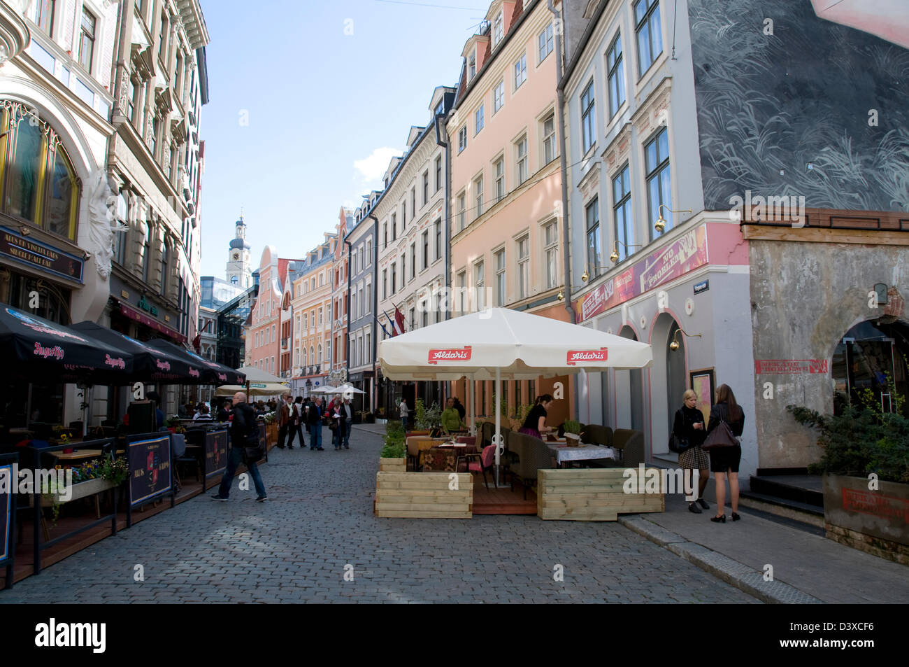 An open-air platform restaurant on the cobbles of Tirgonu iela in Riga Old Town, Riga,Latvia,Baltic States Stock Photo