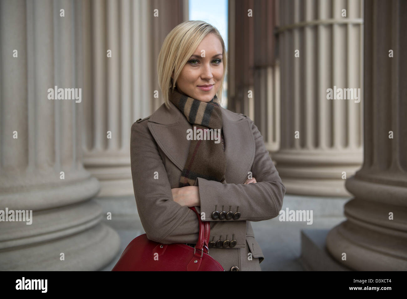 Professional woman by classical columns of government building, Washington DC Stock Photo