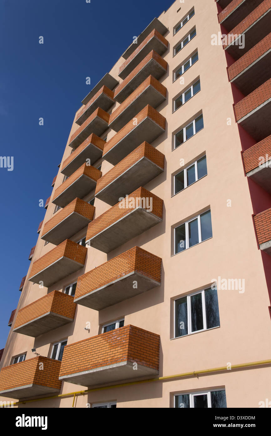 New apartment building on a blue sky Stock Photo - Alamy