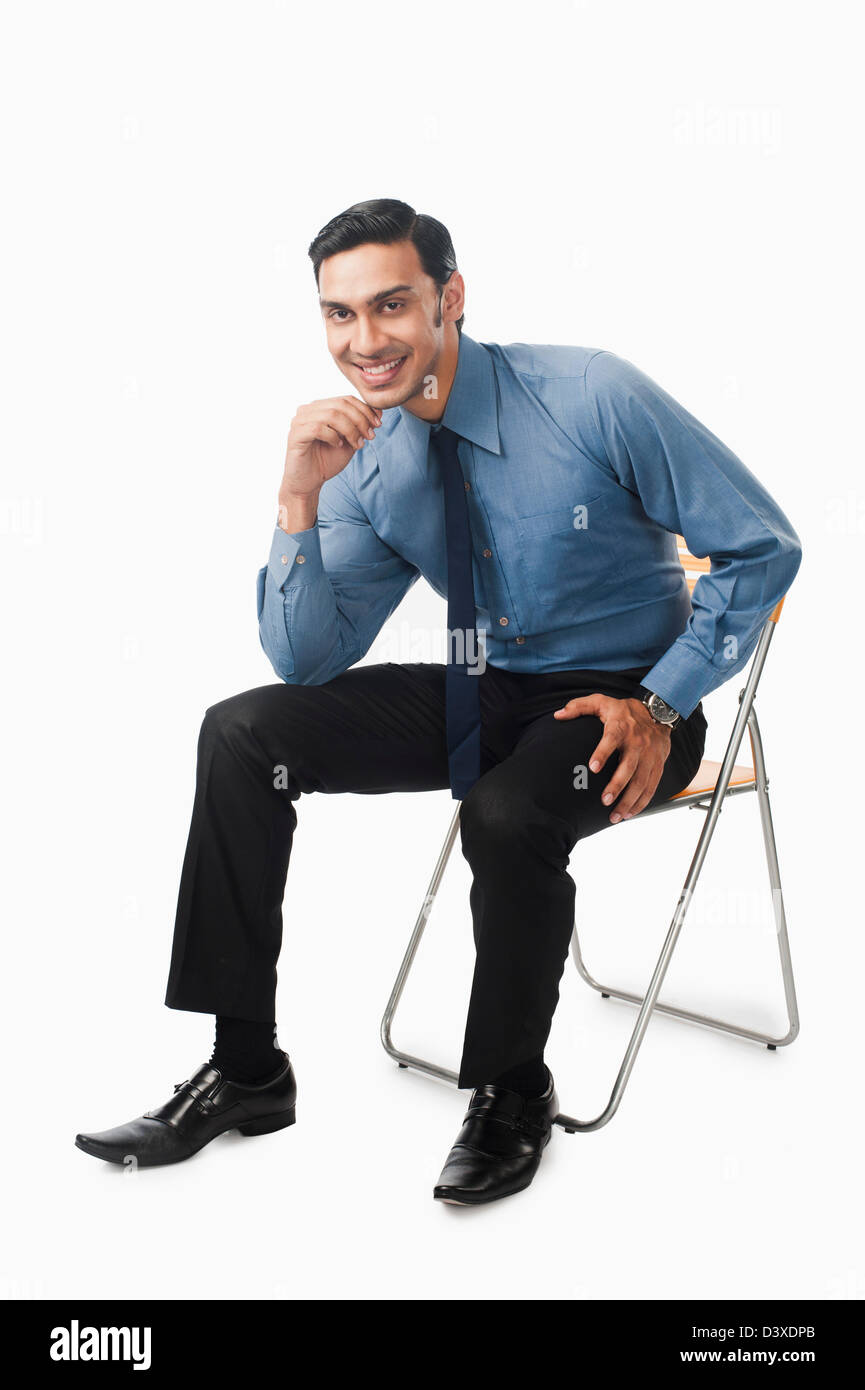Bengali businessman sitting on a chair Stock Photo - Alamy