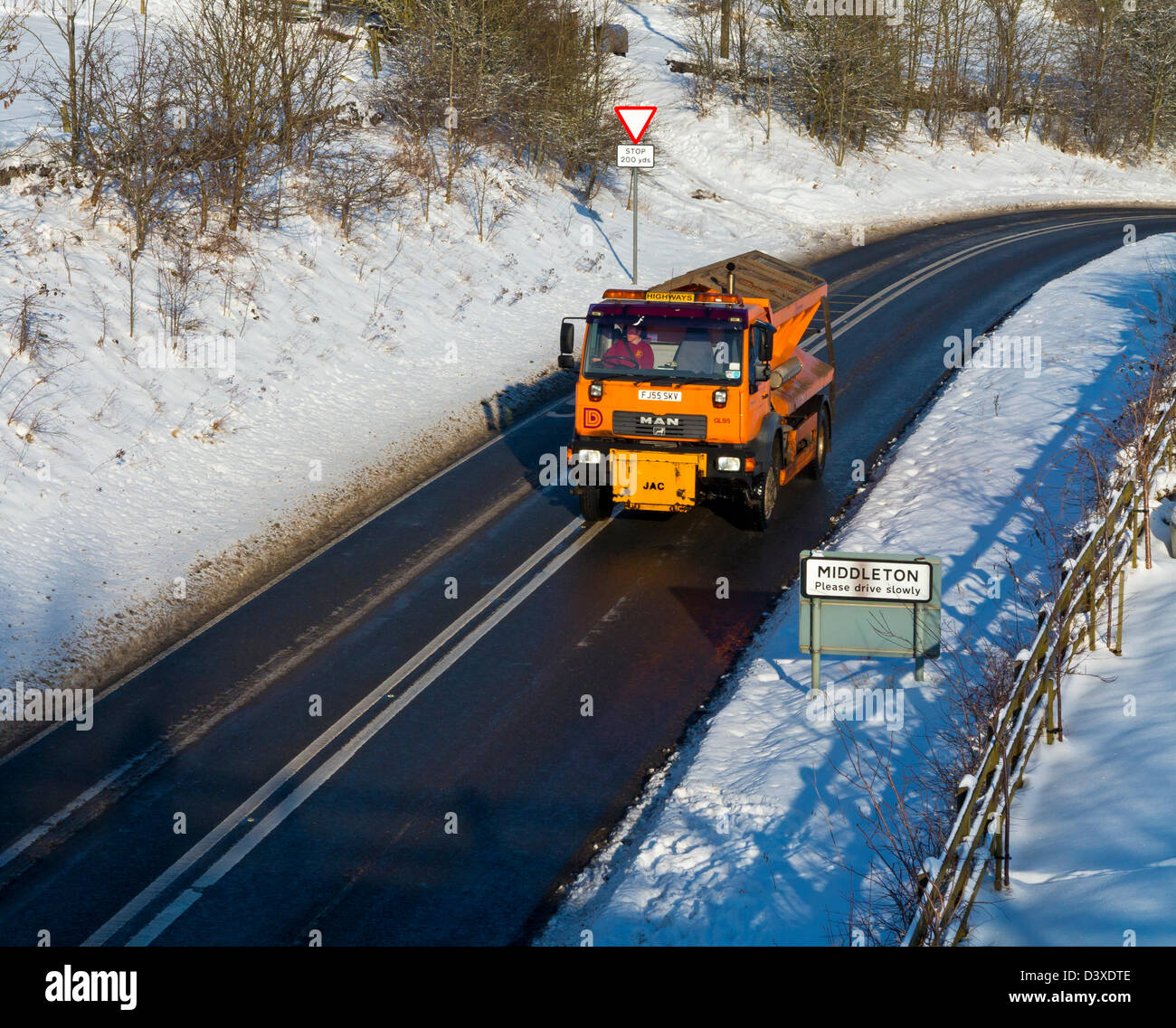 Derbyshire County Council gritting lorry on an icy road after heavy snow Middleton Derbyshire Dales Peak District England UK Stock Photo