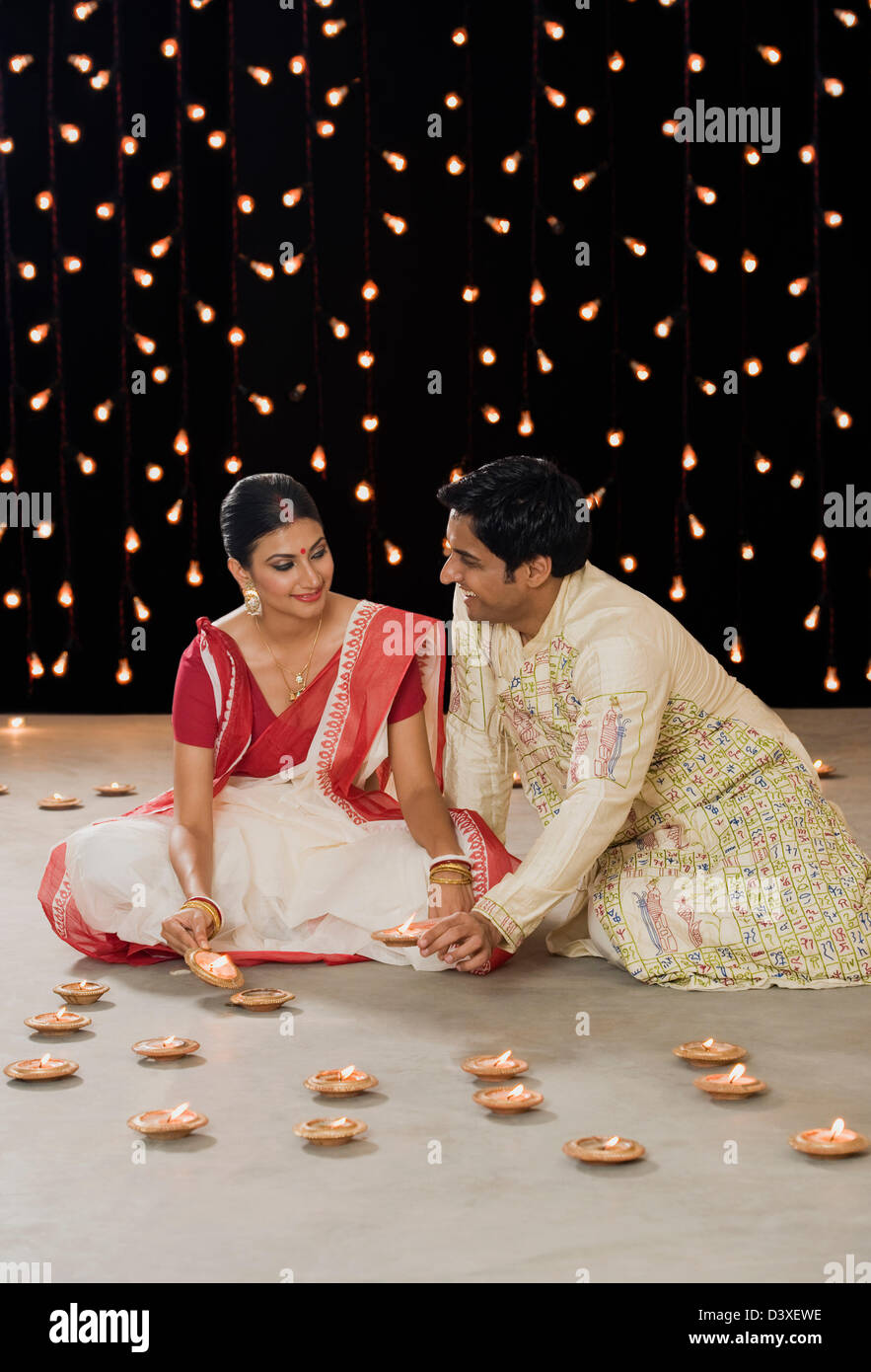 Bengali couple lighting oil lamps Stock Photo Alamy