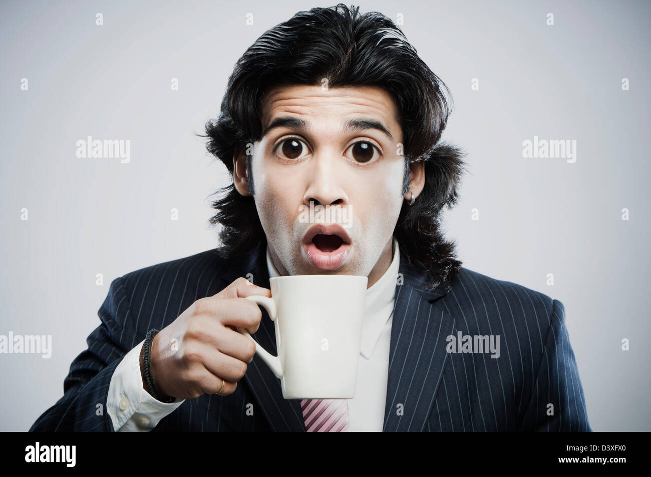 https://c8.alamy.com/comp/D3XFX0/businessman-with-big-eyes-holding-a-cup-of-coffee-D3XFX0.jpg