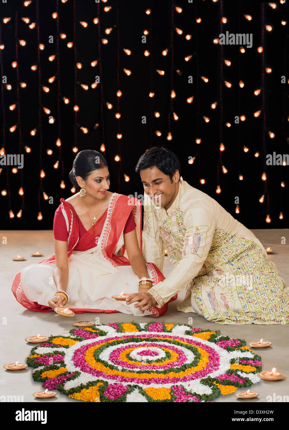 Bengali couple lighting oil lamps Stock Photo Alamy