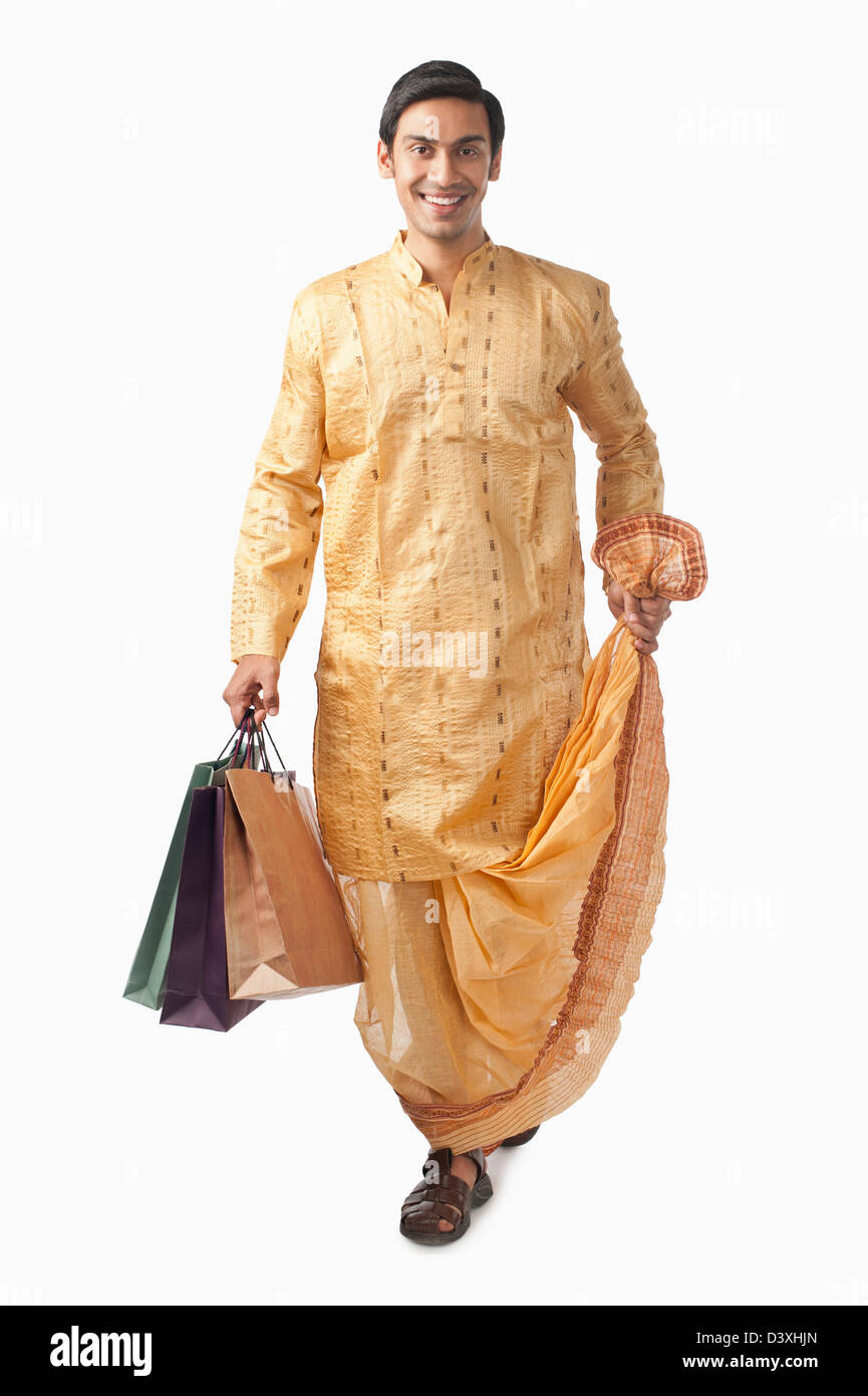 Bengali man carrying shopping bags and smiling Stock Photo Alamy