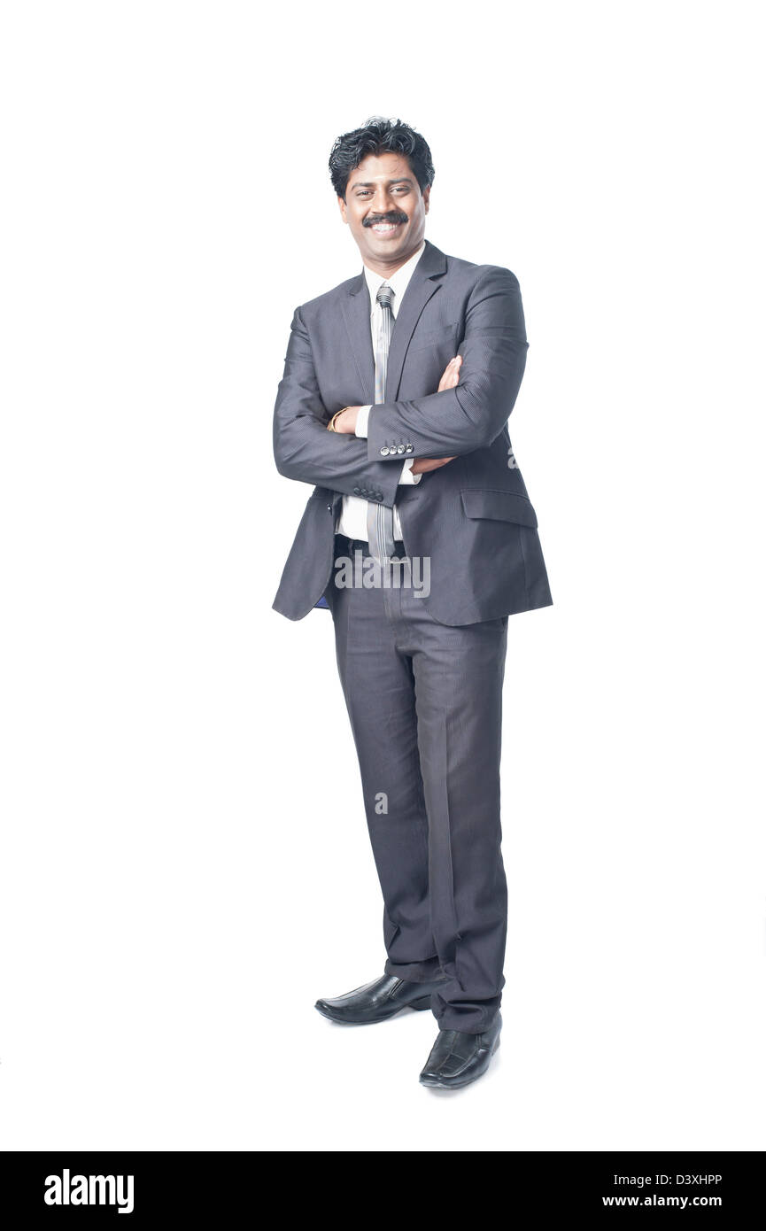 South Indian businessman standing with his arms crossed Stock Photo - Alamy