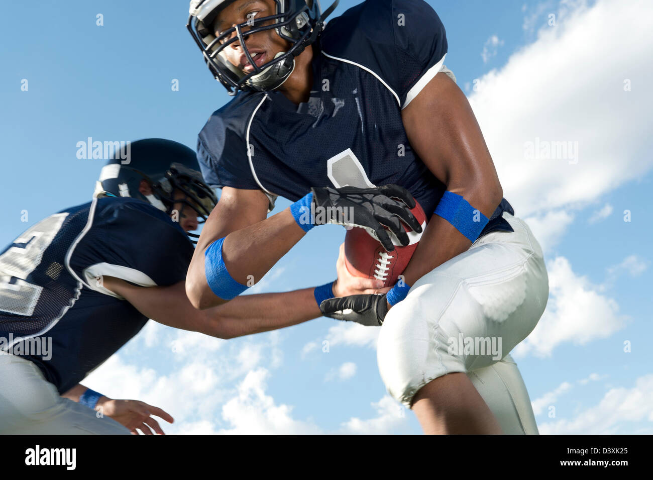 Football players passing ball Stock Photo