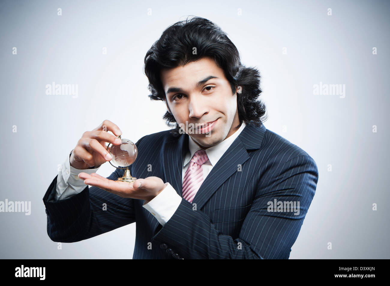 Businessman holding a small crystal globe Stock Photo - Alamy
