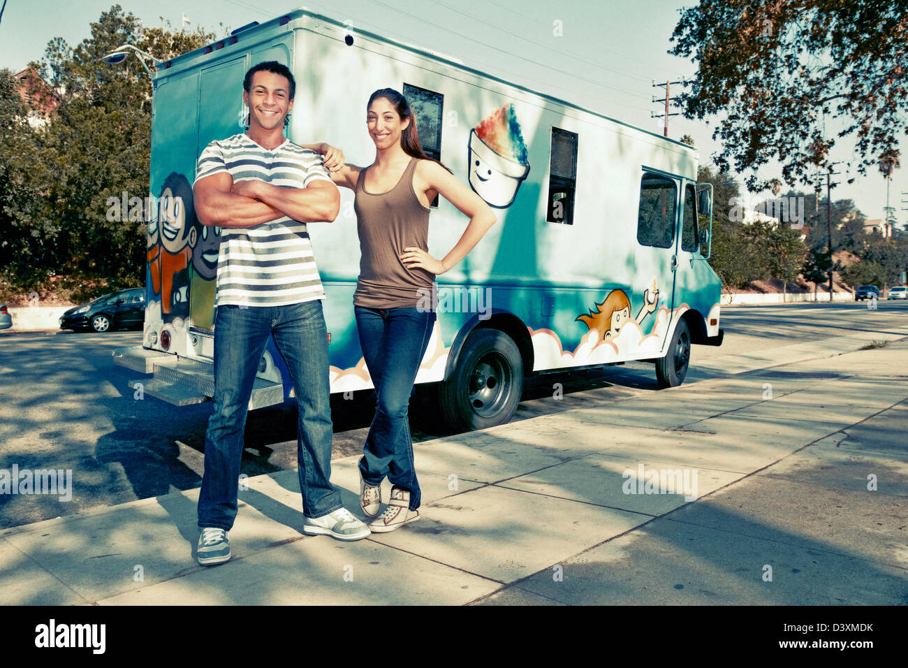 Couple standing by ice cream truck Stock Photo