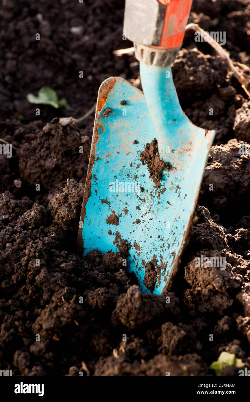 Closeup of gardening tool, small spade in the dirt Stock Photo