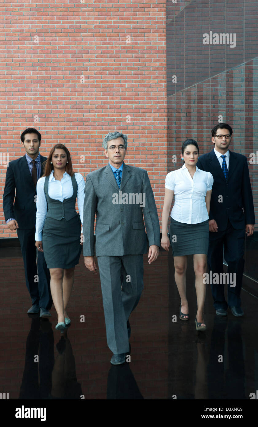 Business people walking together in office Stock Photo - Alamy