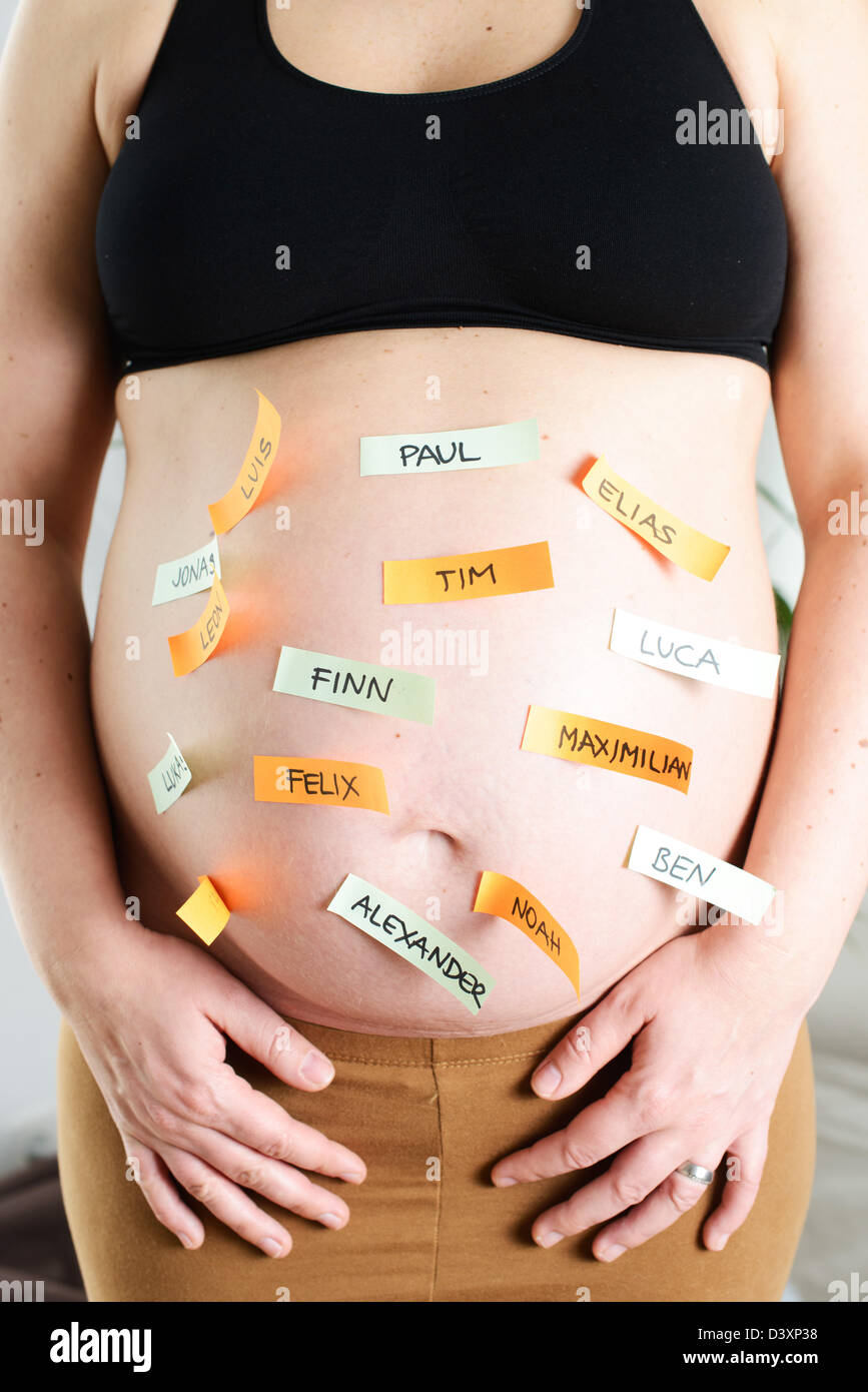 The popular German boy names on a baby belly of a pregnant woman. Stock Photo
