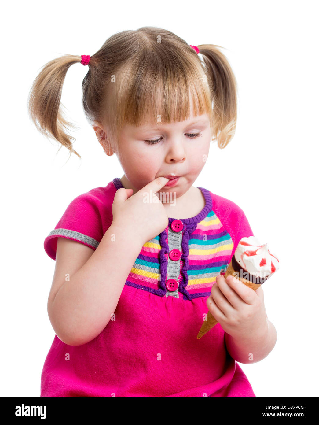 happy kid girl eating ice cream in studio isolated Stock Photo