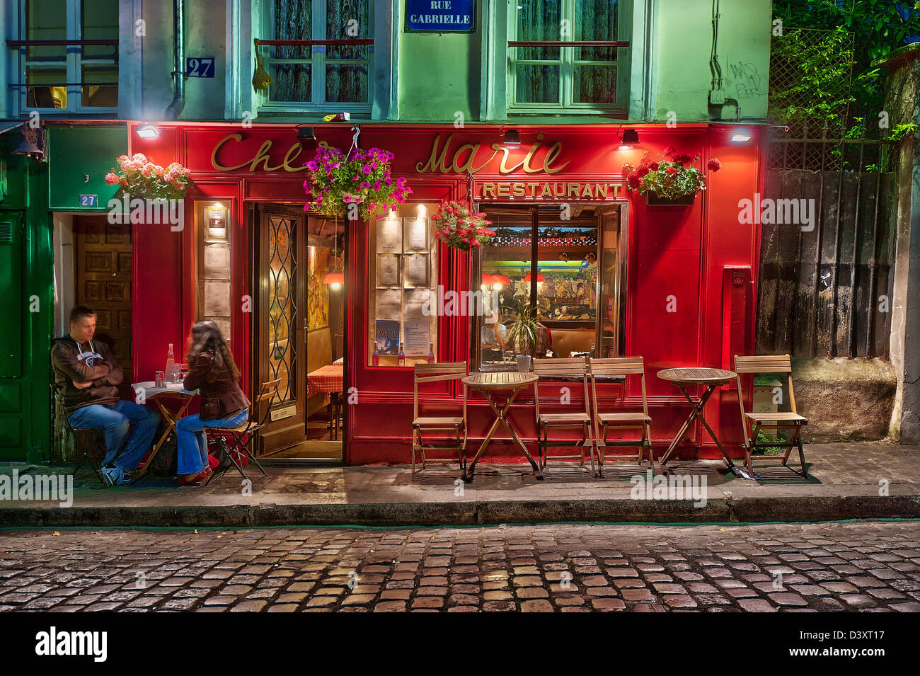 romantic evening for a couple at the terrace of Restaurant “Chez Marie”, 27 Rue Gabrielle, Montmartre, Paris, France Stock Photo