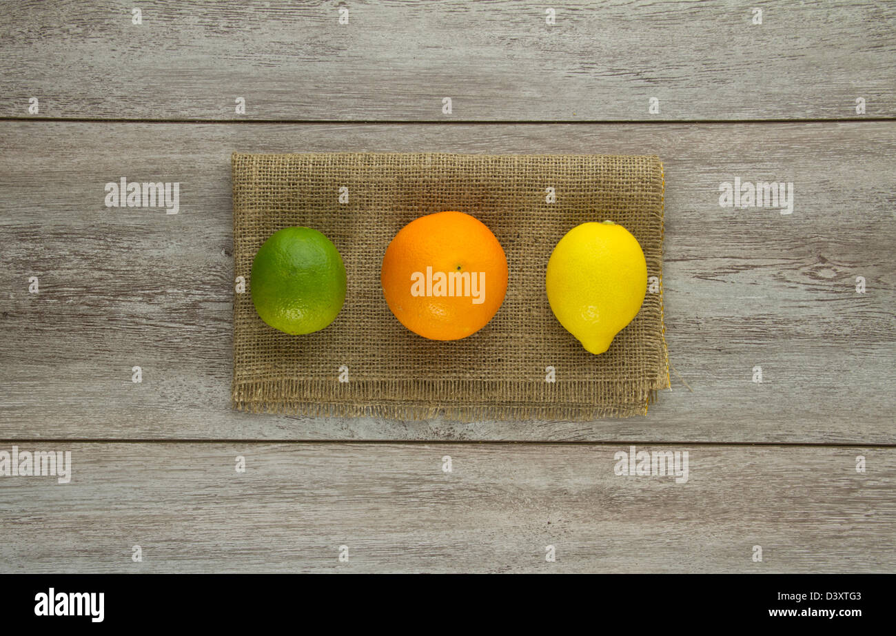 A group of three different citrus fruits (lime, orange, lemon) and ...