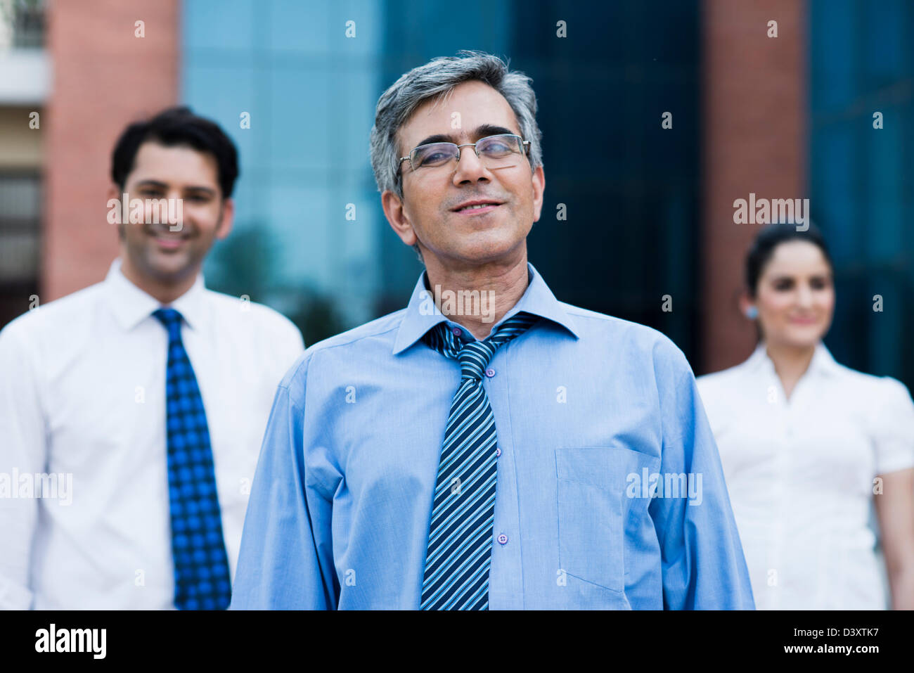 Portrait of a businessman with his colleagues standing behind him Stock ...