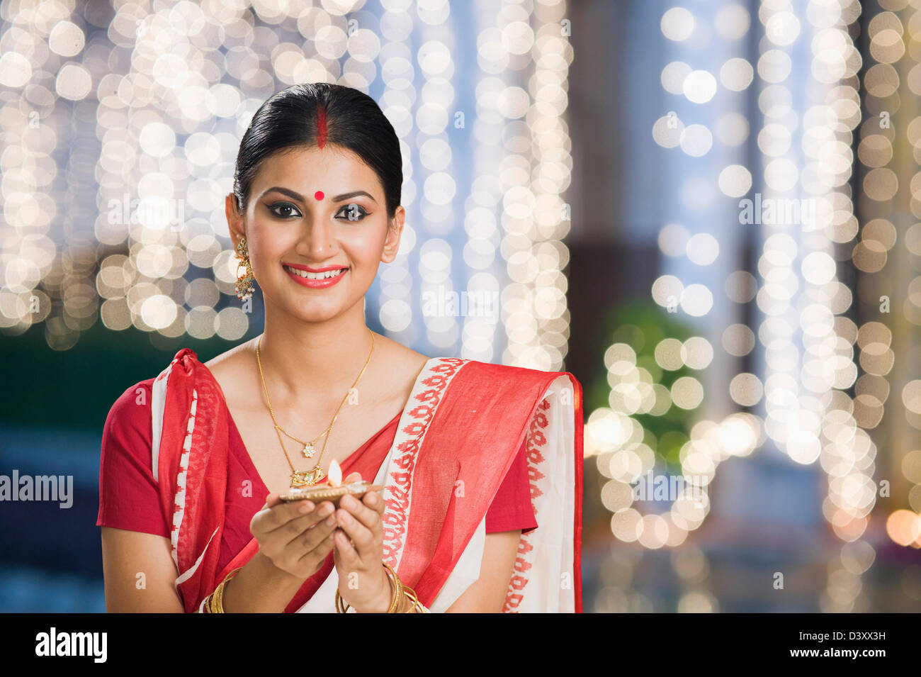 Bengali woman holding an oil lamp Stock Photo Alamy