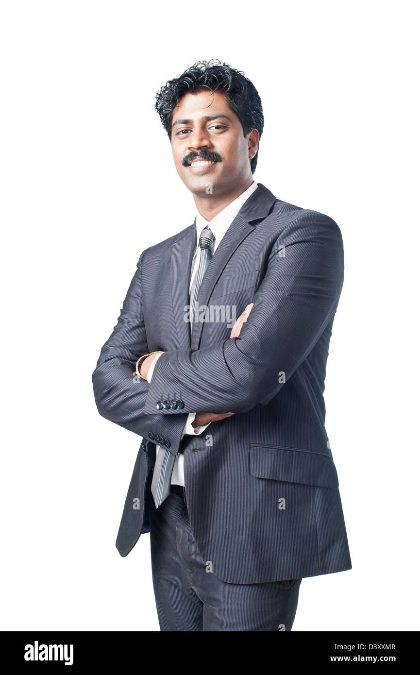 South Indian businessman standing with his arms crossed Stock Photo - Alamy