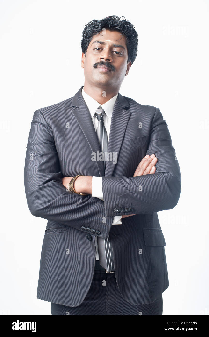 South Indian businessman standing with his arms crossed Stock Photo - Alamy