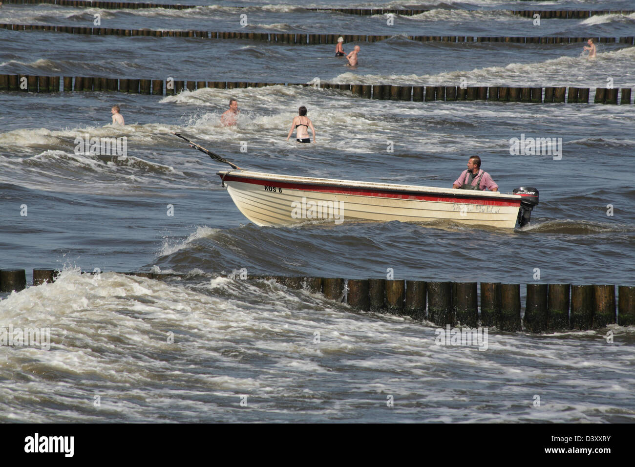 Koserow, Germany, timber groynes in the Baltic Sea and fishing boat