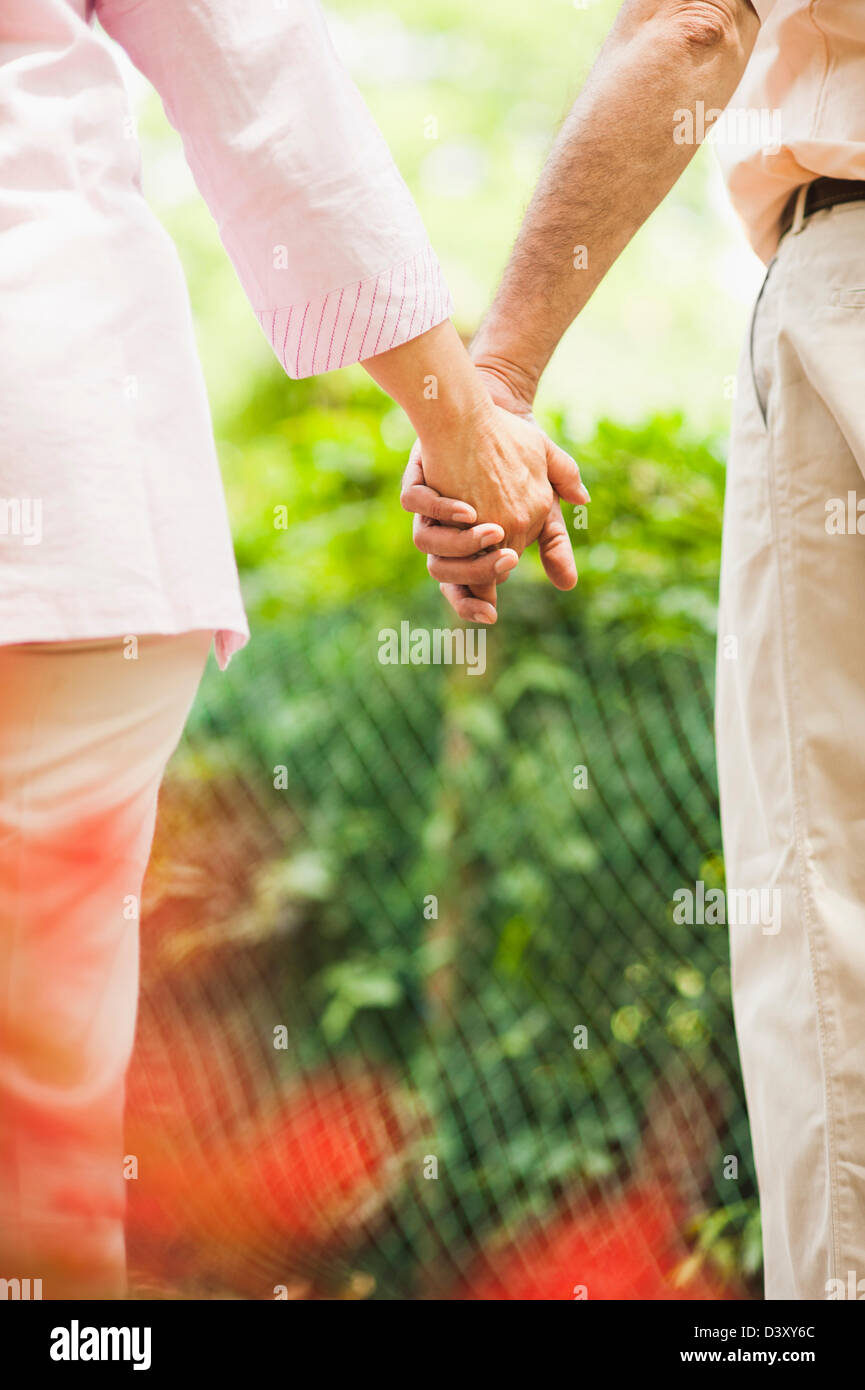 Mature couple holding hands of each other, Lodi Gardens, New Delhi, India Stock Photo