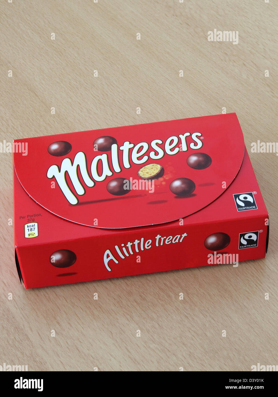 Box of Maltesers on a Wooden Background Stock Photo