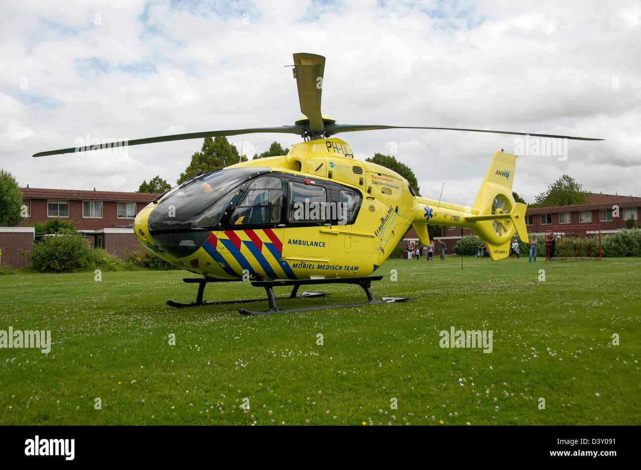 Yellow trauma helicopter on the ground for help in Holland Stock Photo