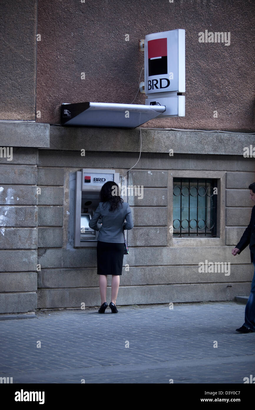 Sibiu, Romania, woman gets money from the ATM of the bank BRD Romania Stock Photo