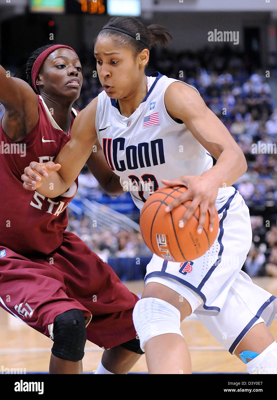 Hartford CT USA- UCONN's Maya Moore drives past Florida State's Christian Hunnicutt during the first half. Women's Basketball Stock Photo