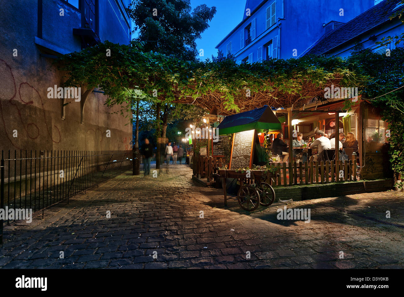 People dining at the terrace of restaurant “Chez Plumeau” on Rue Poulbeau, Montmartre, Paris, France Stock Photo