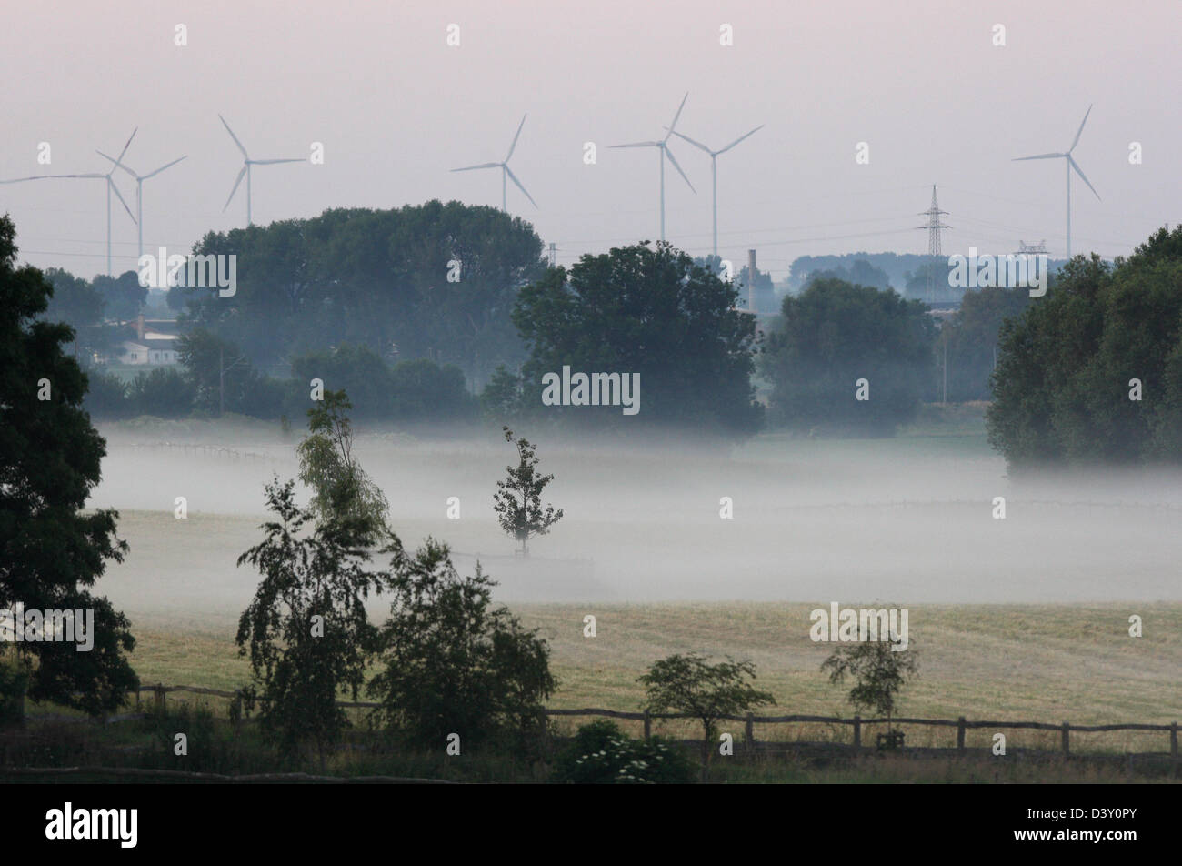 Görlsdorf, Germany, wind wheels behind a misty pasture Stock Photo