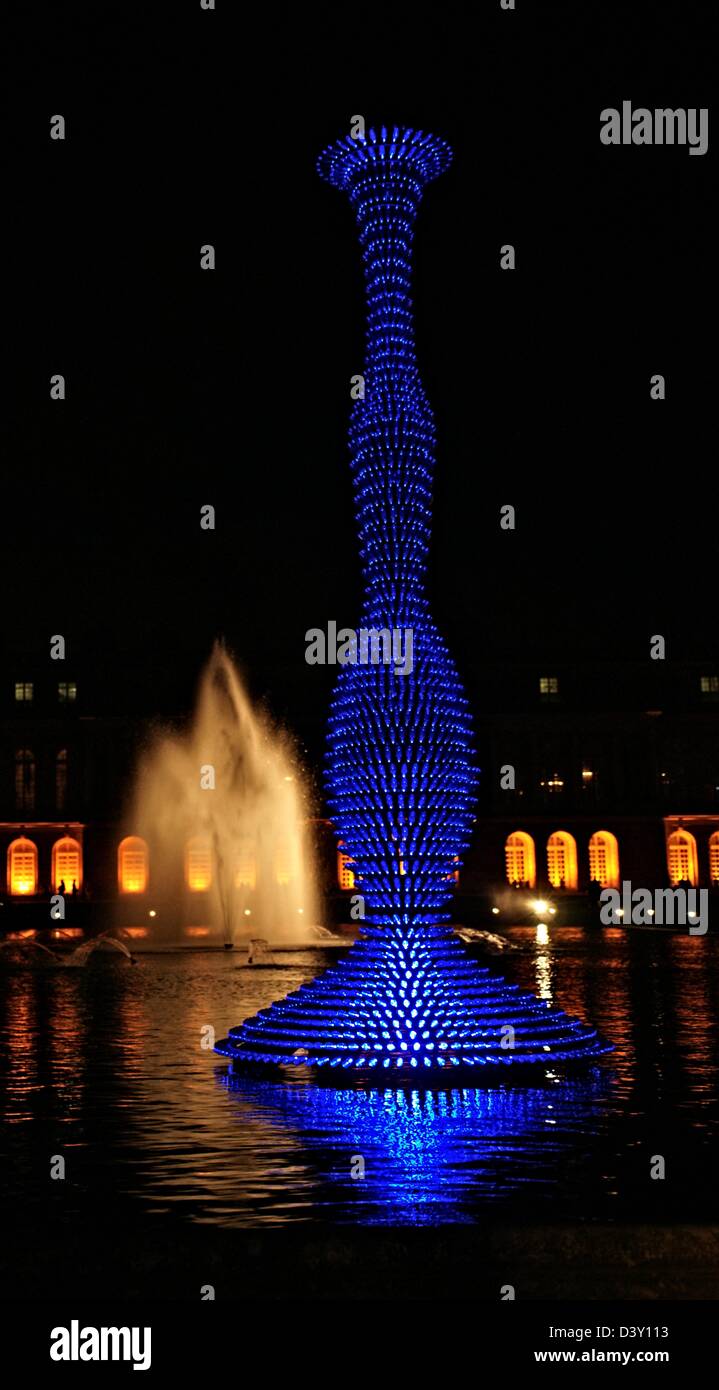 Illuminated Blue Glass Sculpture in the Gardens of the Chateaux de Versailles at Night Stock Photo
