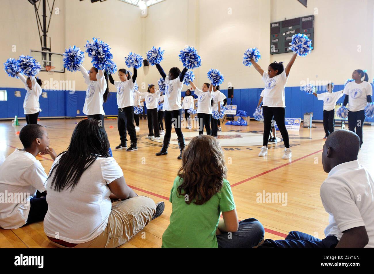 Young Cheerleaders perform at a school gymnasium in CT USA Stock Photo