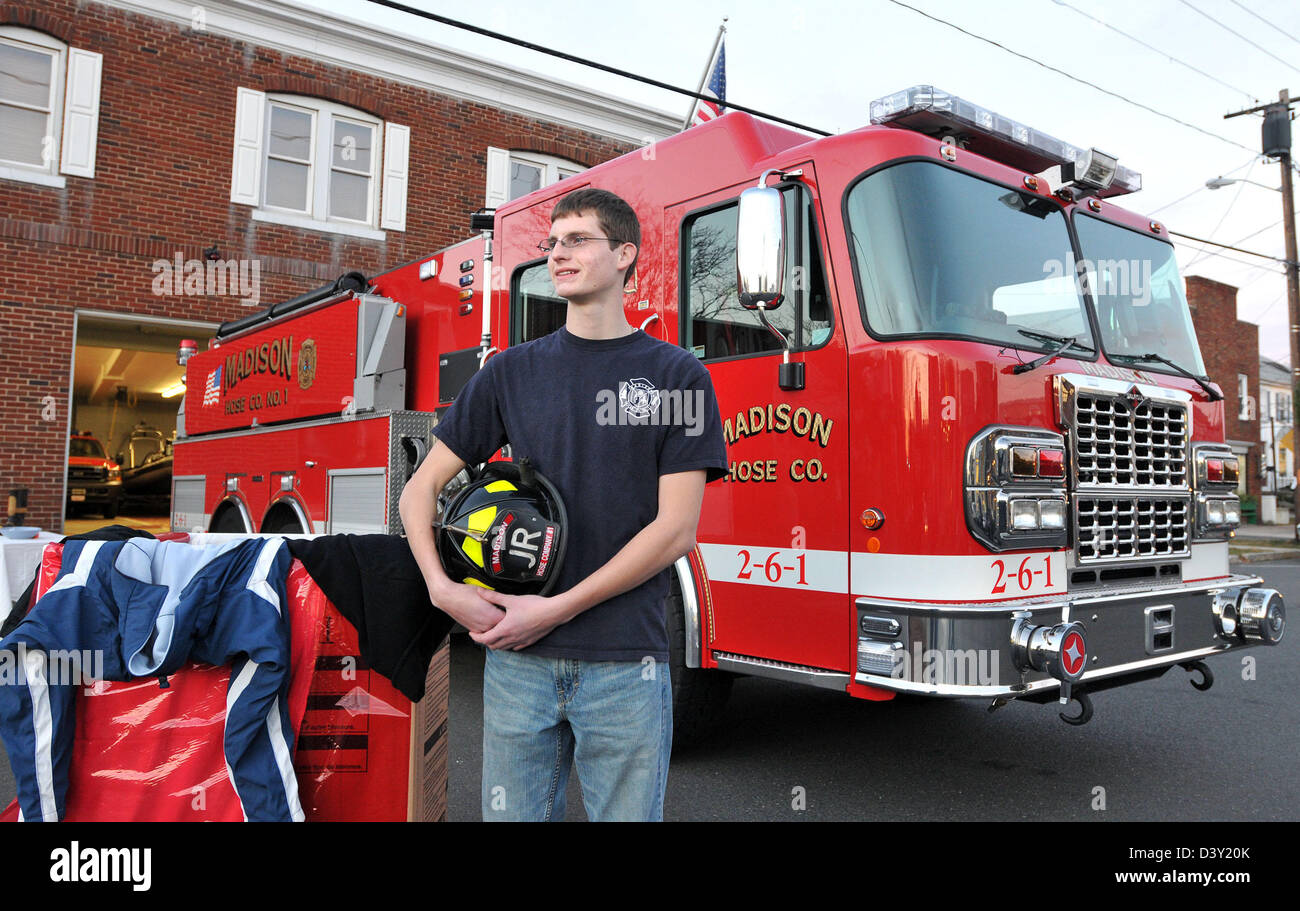 Volunteer Junior firefighter helps collect money and coats for the needy people in the community in Madison, CT USA Stock Photo