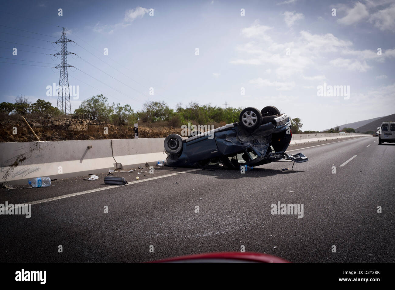 Car crash with car on it's roof on a motorway photographed from a passing vehicle Stock Photo