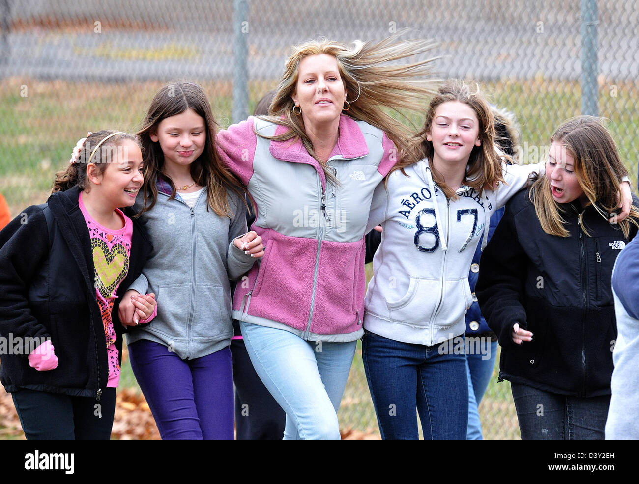 Parents and students walk cheerily as they raise money for a parent of fellow student with cancer in Connecticut USA Stock Photo