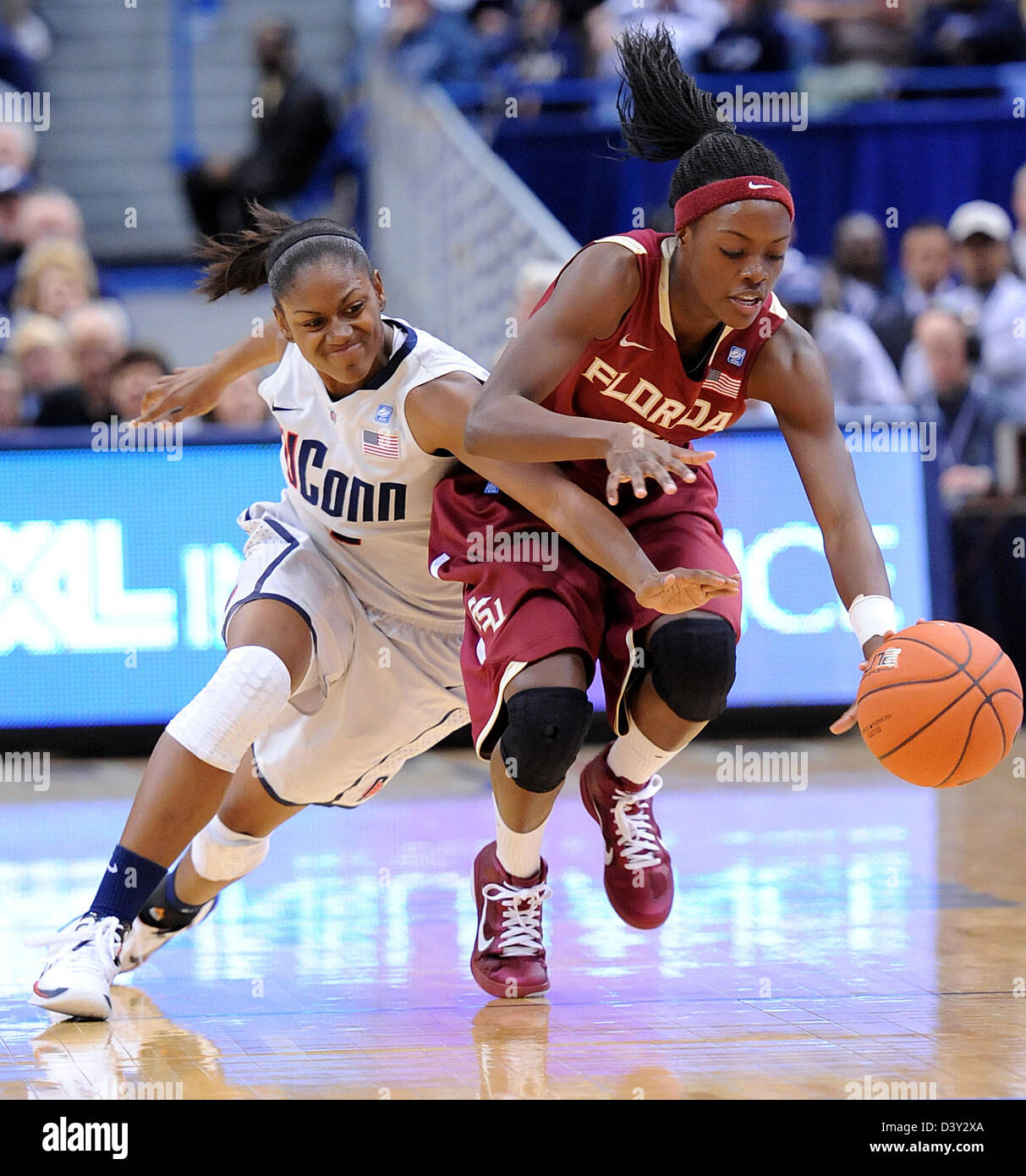 UCONN's Tiffany Hayes battles for a loose ball with Florida State's Christian Hunnicutt during the first half. Stock Photo