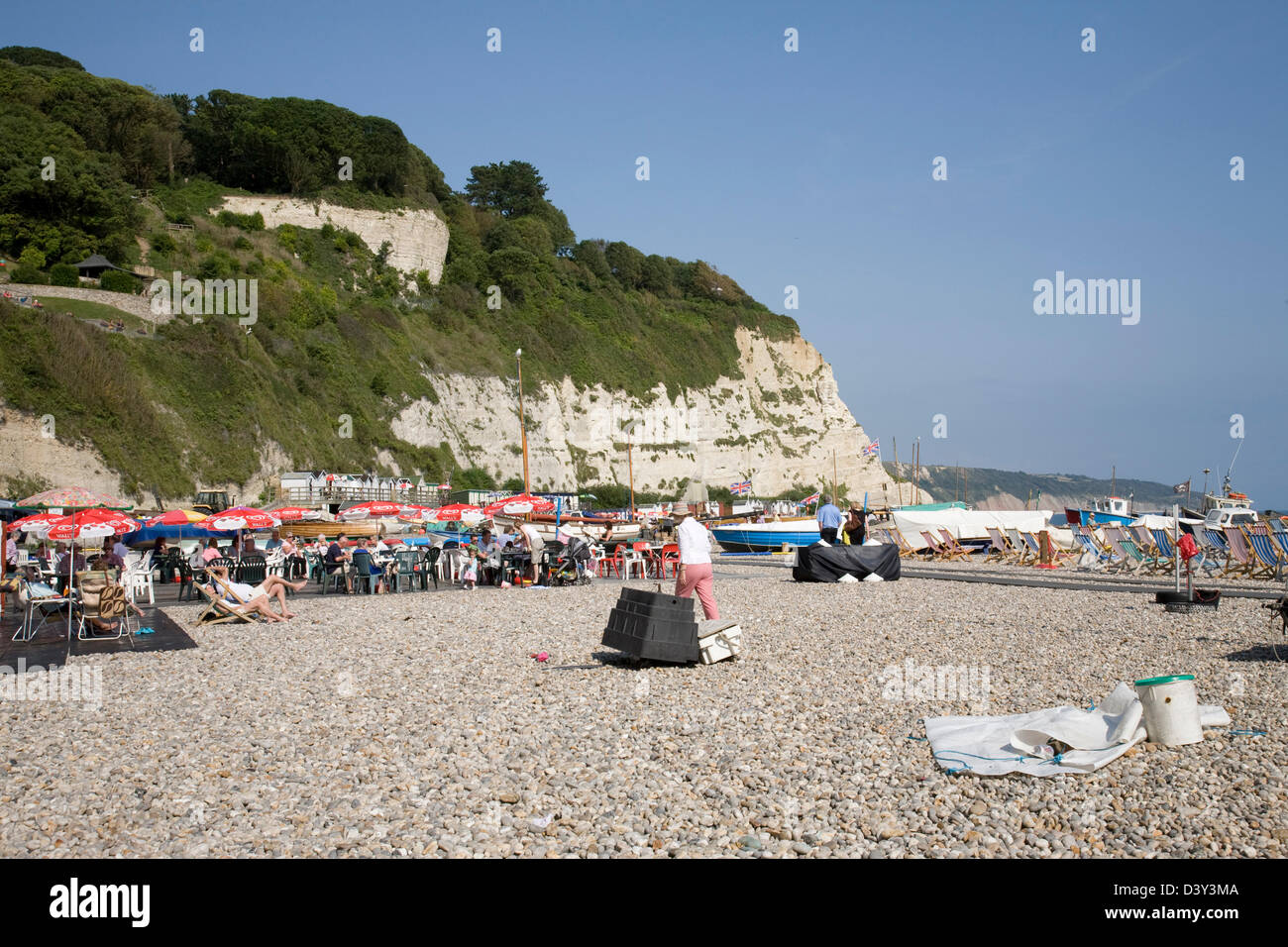 Holidaymakers relaxing at one of the beach cafés at Beer in Devon, England. Stock Photo