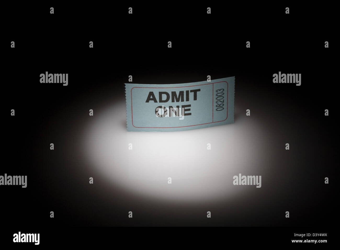 An event or admission ticket in a spotlight - admit one. Stock Photo